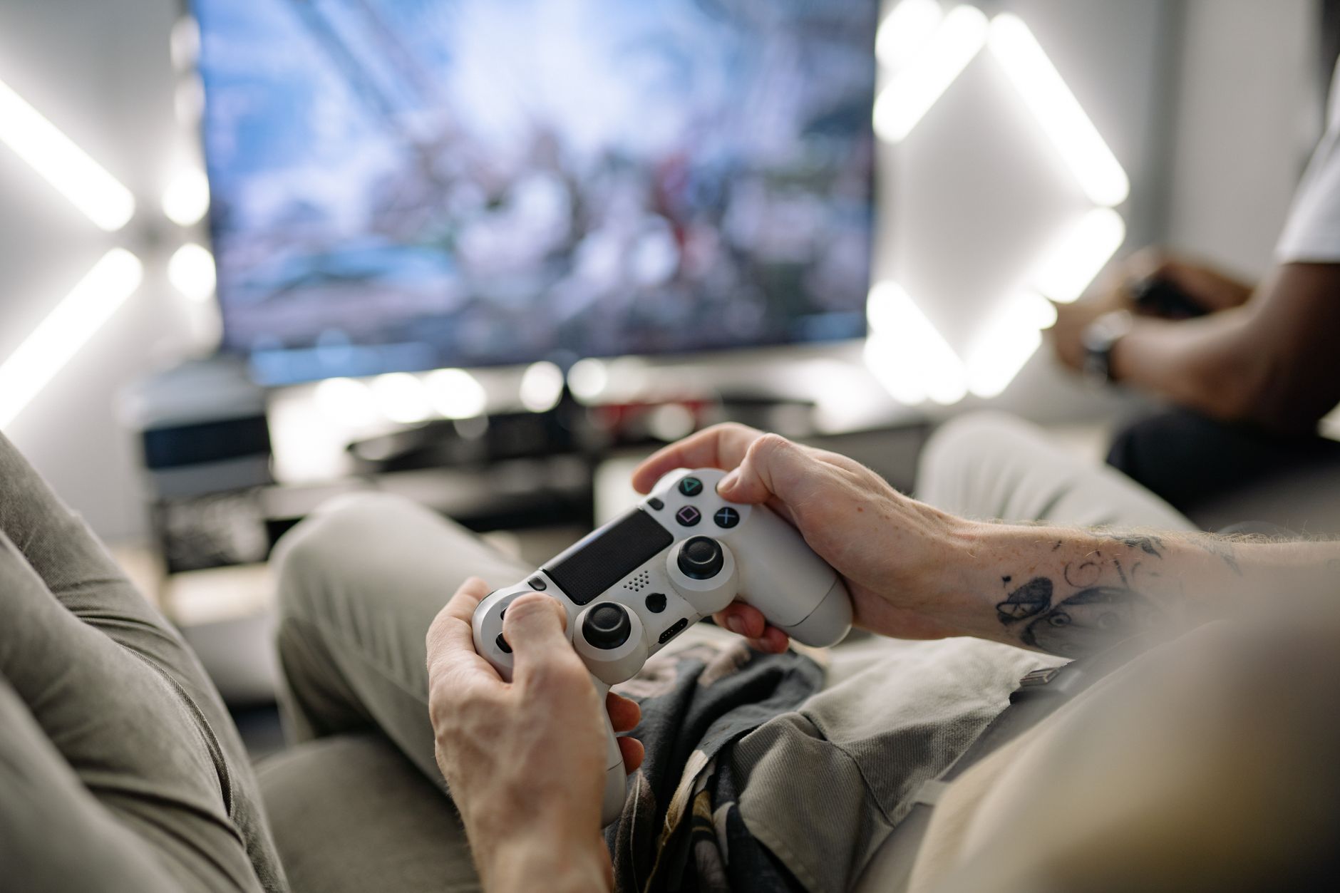 Hands holding a video game controller in a modern living room, playing on TV. — Deposit Methods at Online Casinos Canada Play