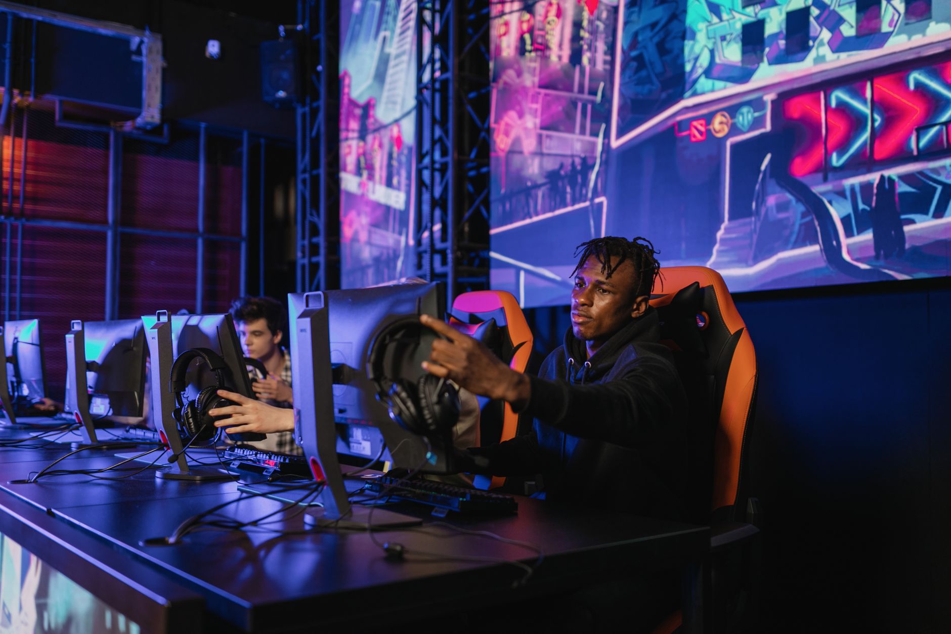 Two gamers intensely focused in a professional eSports competition with vibrant game visuals. — The Data Behind UFA656 Digita